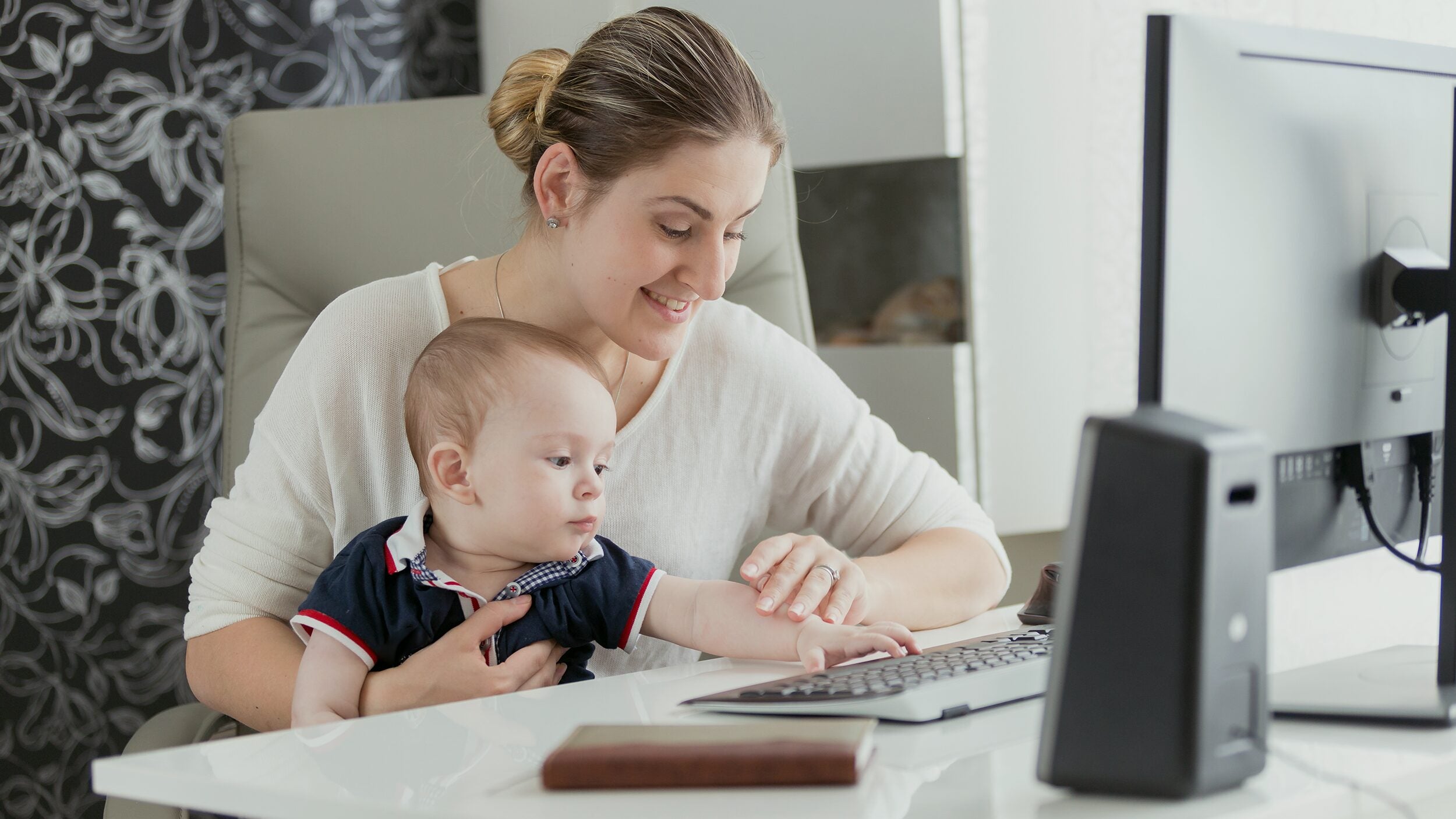 Woman with child working on school work.