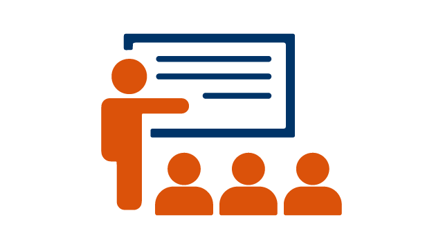 Person presenting information in front of an audience.