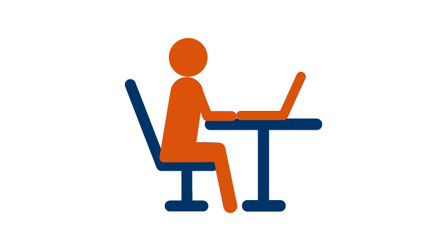 Person sitting at a table and using a laptop.